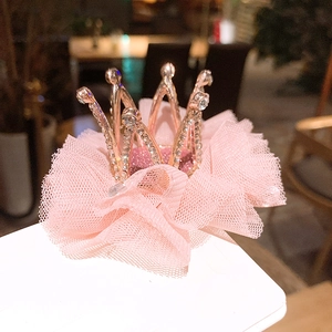 Detail of pink mesh crown hair clip with gold base and sparkling crystal rhinestones