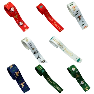 Macro view of assorted Christmas ribbon rolls with festive holiday patterns and text
