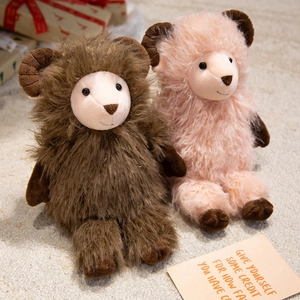 Cute plush stuffed sheep toys in brown and pink sitting on a cozy white rug