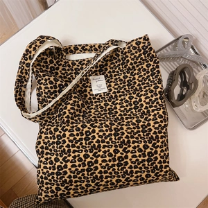 Macro shot of leopard print canvas tote bag with a minimalist white fabric label