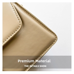 Close-up of beige leather shoulder bag showing fine grain texture and precise stitching