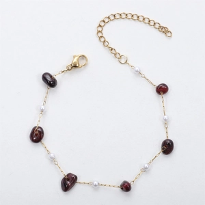 Detailed view of 18K gold chain with deep red natural stones and small white pearls