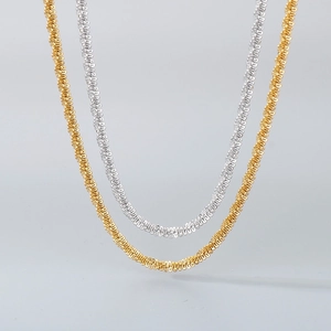 Detail view of gold and silver twisted rope chains in polished stainless steel finish