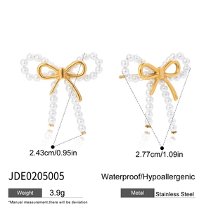 Detailed view of gold bow earrings with pearls showing size measurements and material specs