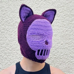 Detail of handmade purple crochet balaclava with skull face pattern and cat ears