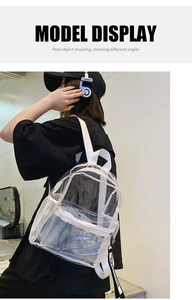 Detail view of transparent PVC backpack showing side mesh pocket and adjustable letter straps