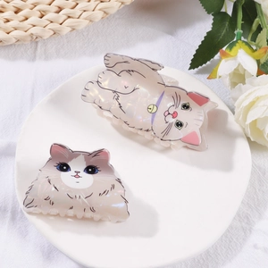 Cute pearlescent cat hair claws with cartoon kitten shapes in white and beige colors