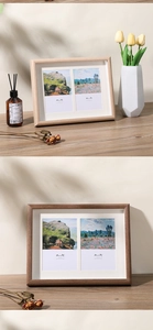 Detail of wooden double photo frames in light oak and dark walnut finishes on a desk