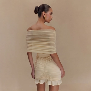 Détail du tissu en maille plissée et de l'ourlet volanté au dos de la mini-robe jaune