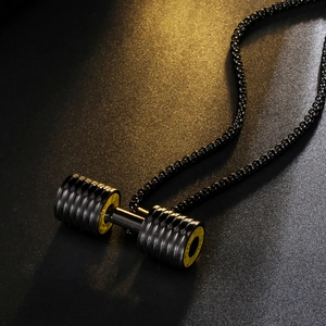 Macro detail of black dumbbell necklace pendant with yellow GO FIT text and box chain