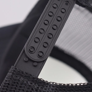 Detail view of the durable black plastic snapback closure on a mesh trucker hat
