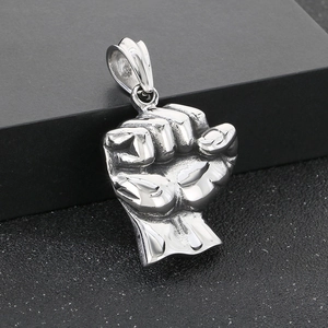 Detailed close-up of a silver solid fist pendant for men with metallic texture