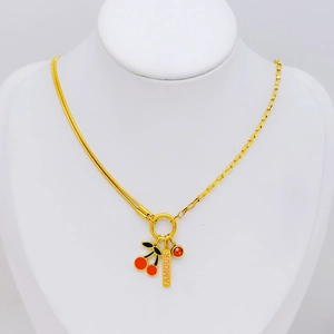 Gold cherry pendant necklace with Amour tag on white jewelry display stand