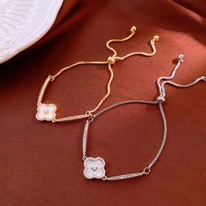 Detail of clover bracelet with zircon inlay and adjustable slide buckle on velvet
