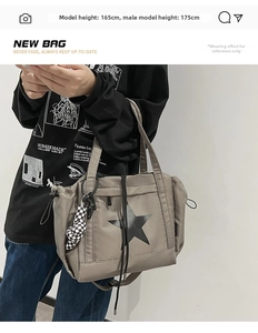 Detail of grey nylon star tote bag with checkered charm and drawstring on model