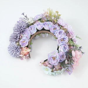 Detail of colorful artificial fabric flowers and green leaves on an ethnic style headband
