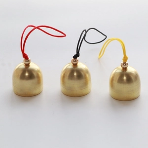 Set of 2cm golden metal Christmas bells with colorful cords on a white background