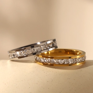 Macro detail of gold and silver stainless steel rings set with square-cut zircons