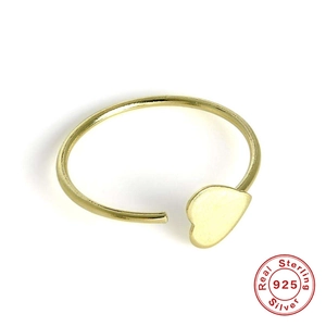 Close-up of golden S925 sterling silver nose ring with heart design on white background