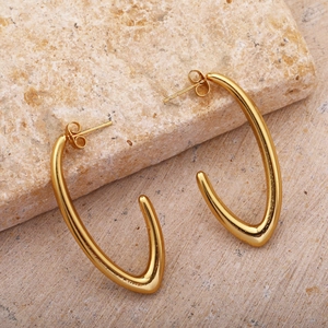 Polished gold C-shaped crescent earrings on natural stone background, French vintage style