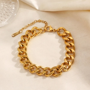 Golden stainless steel Cuban link bracelet for women featuring a lobster clasp and extension