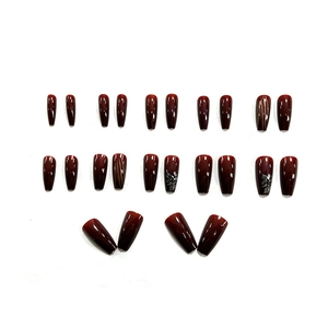 Deep cherry red long trapezoid press-on nails with floral patterns and striped accents