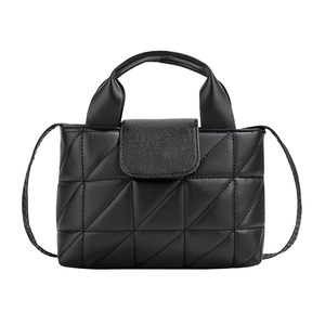 Chic black quilted handbag with geometric patterns and top handle in a front studio view