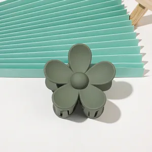 Macro detail of matte Morandi green flower hair claw clip with frosted finish texture