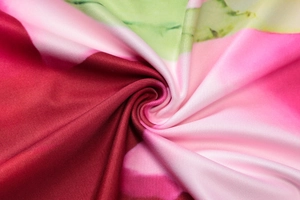 Macro detail of abstract print on knit fabric showing soft texture and draping