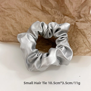 Detail of small silver PU leather hair tie with metallic texture and 10.5cm size