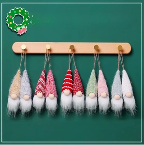 Set of 10 knit Christmas gnome ornaments with long plush beards hanging on wood rack