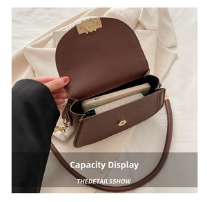 Internal view of brown crossbody bag showing capacity for phone and wallet details