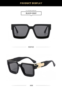 Detail view of square black sunglasses with gray lenses and gold metal temple accents