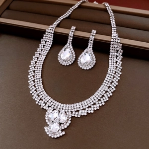 Silver rhinestone necklace and earrings set presented in a brown jewelry gift box