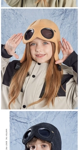 Detailed close-up of kids aviator hat with goggles decoration and ribbed knit texture