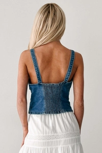 Detail of smocked elastic back on blue denim camisole top with slim straps