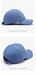 Detailed close-up of blue washed cotton baseball cap with distressed brim and metal buckle