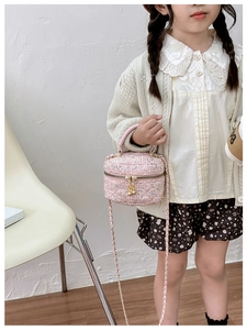Pink sequin tweed cylinder bag for girls with chain strap shown by a child model