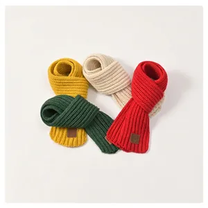 Soft knitted scarves for kids in yellow, white, green and red colors for winter warmth