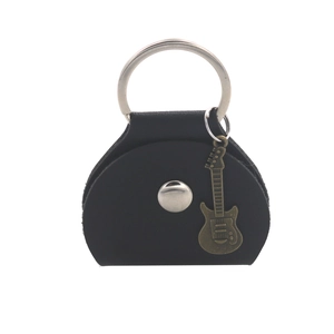 Detailed view of black leather guitar pick pouch with vintage guitar pendant and metal ring