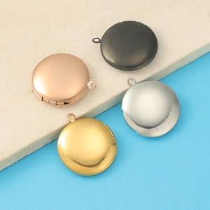 Detail view of round 316L stainless steel photo locket pendants in four metallic colors