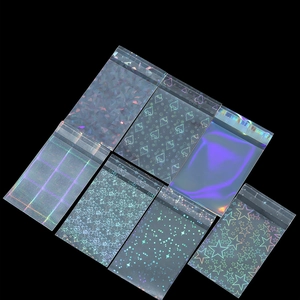 Macro detail of laser holographic self-sealing bags in star, heart, and cherry patterns