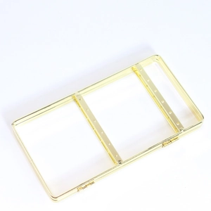 Three-tier gold metal jewelry display stand with multi-hole crossbars on white background