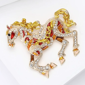 Macro shot of gold pony brooch with colorful enamel details and sparkling crystals