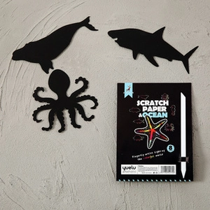 Macro view of ocean-themed scratch art paper set with sea animal designs and stylus