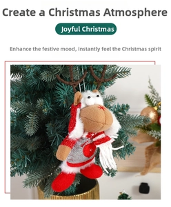 Detail of plush Christmas reindeer ornament with red scarf hanging on a festive tree