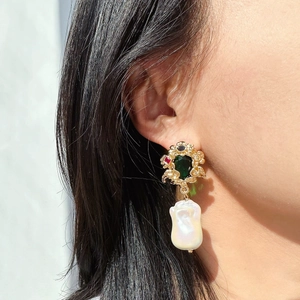 Vintage gold vine earrings with emerald gems and large baroque pearls on model