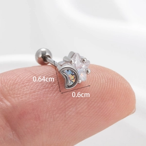 Macro shot of silver star and moon cartilage stud earrings with size measurements