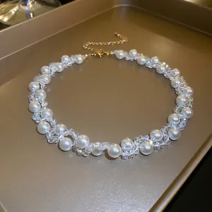 French vintage necklace with faux pearls and crystals on a gold tray background