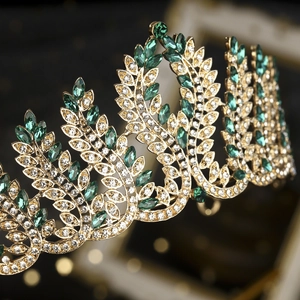 Luxurious gold Baroque bridal crown with emerald green crystals and vintage leaf patterns